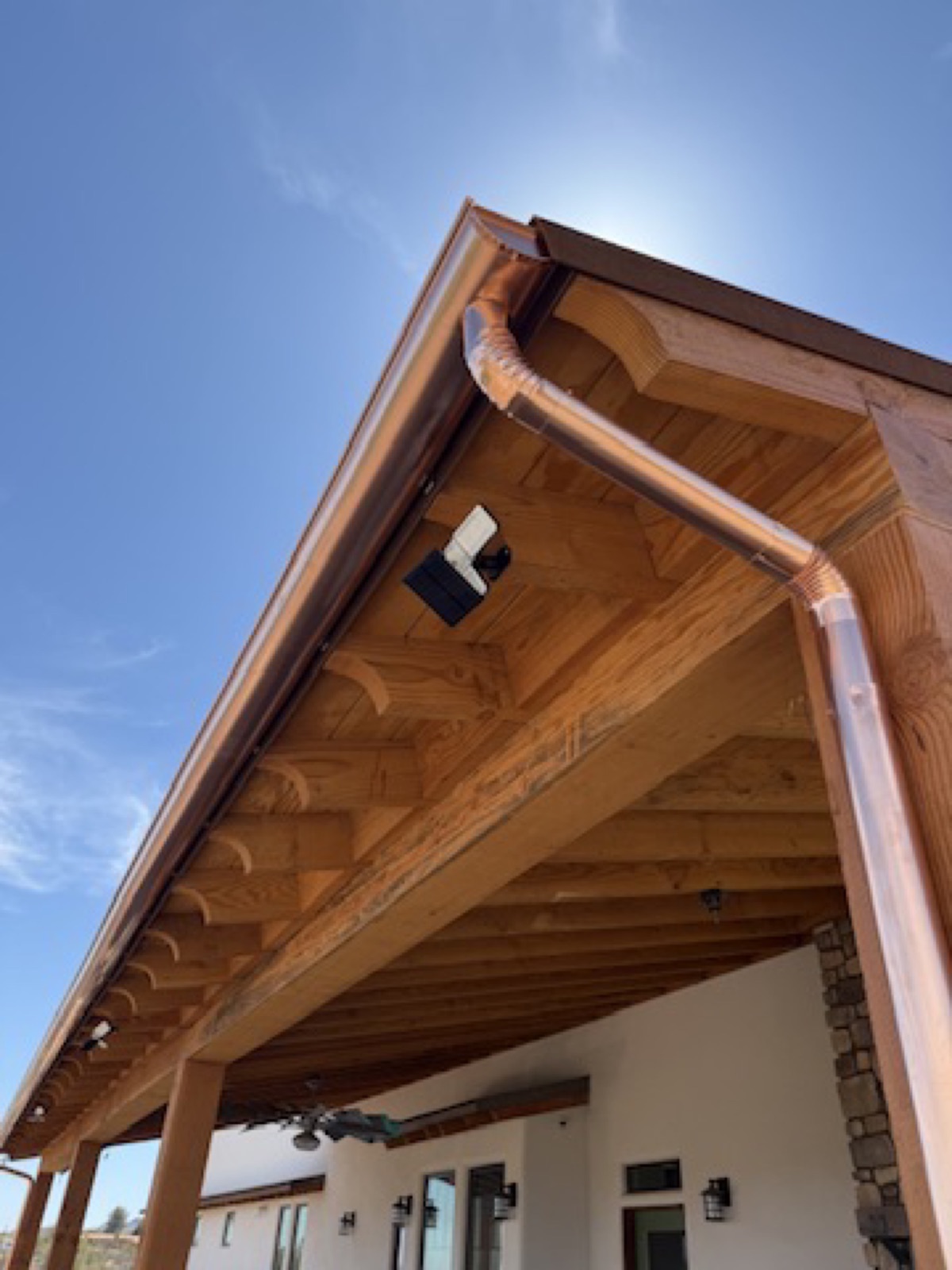 City Seamless half-round rain gutter with downspout routing on a custom home.