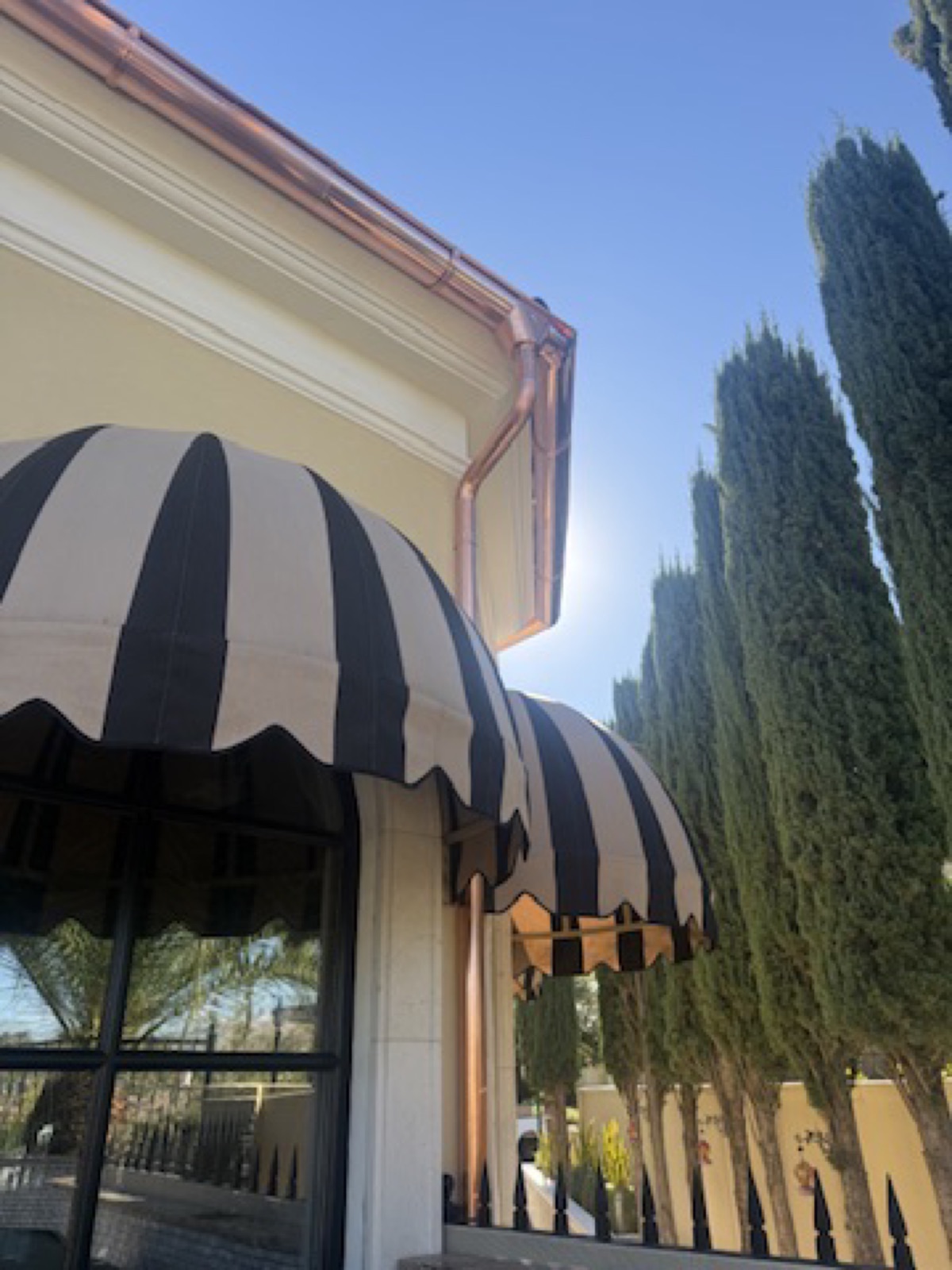 City Seamless half-round rain gutter with downspout routing on a custom home.