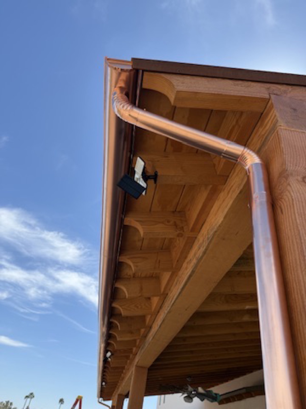 City Seamless half-round rain gutter with downspout routing on a custom home.