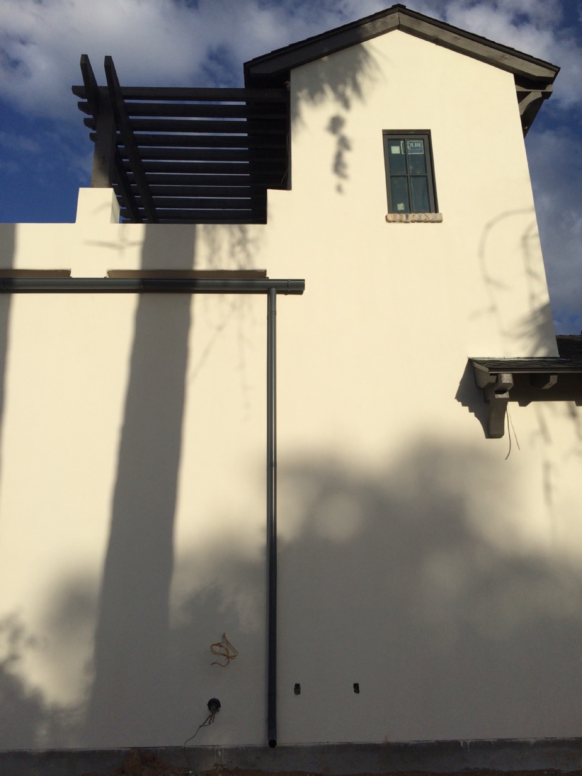 City Seamless half-round rain gutter with downspout routing on a custom home.