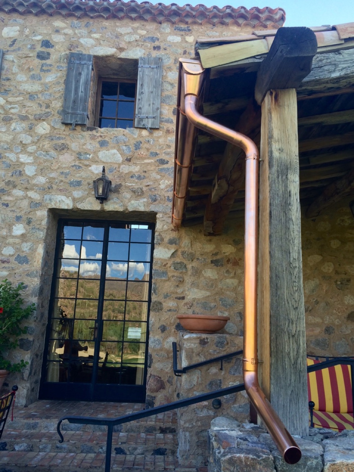 City Seamless half-round rain gutter with downspout routing on a custom home.