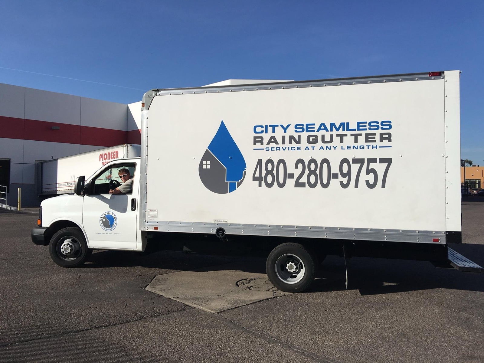 City Seamless rain gutter installation crew and equipment photo.