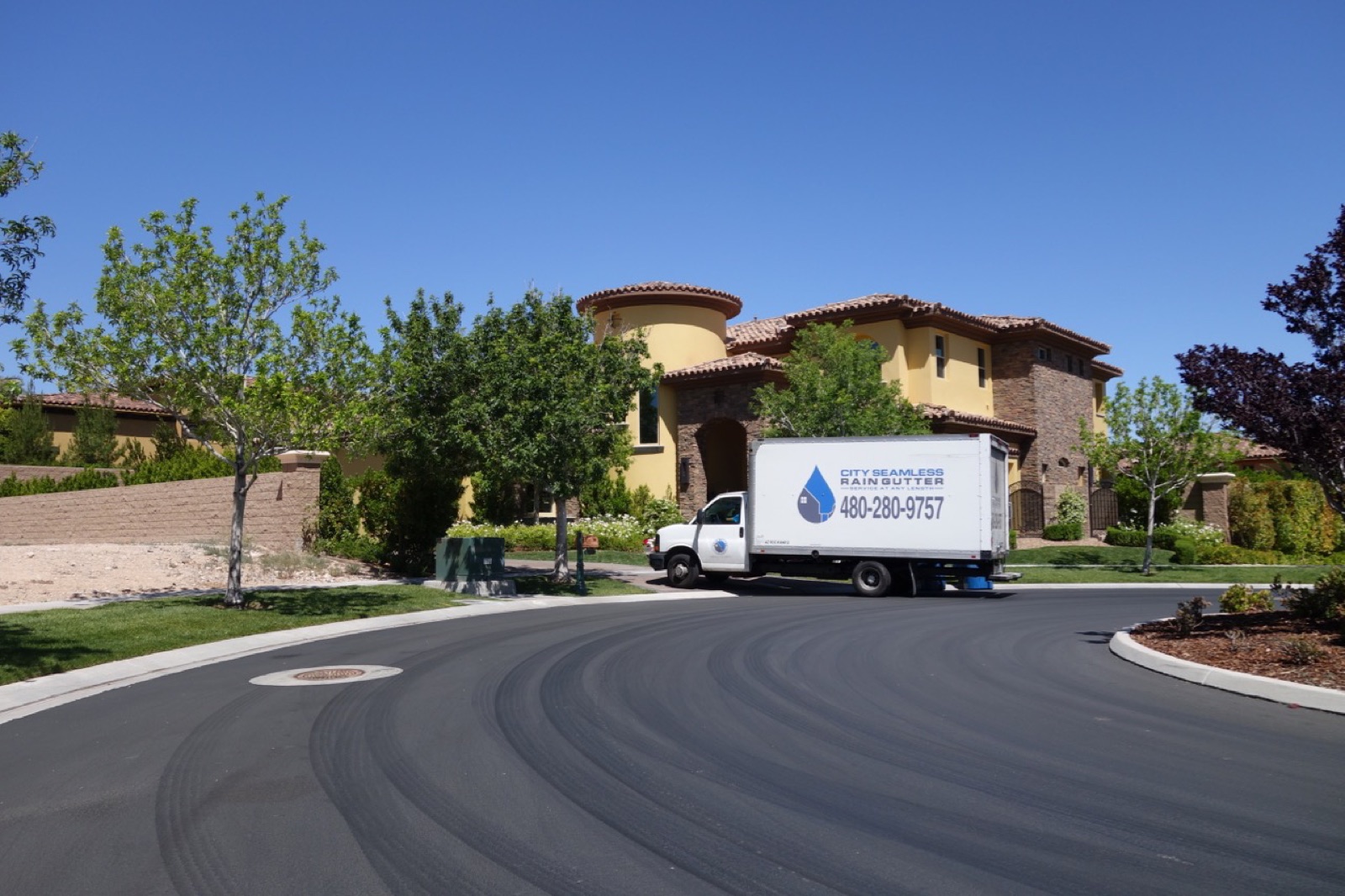 City Seamless rain gutter installation crew and equipment photo.