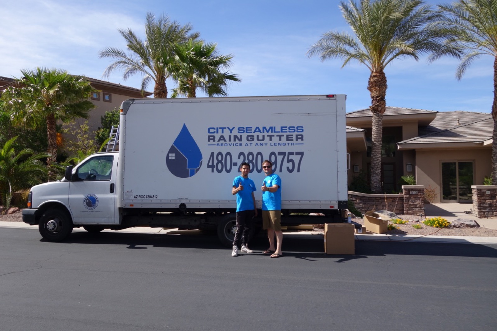 City Seamless rain gutter installation crew and equipment photo.