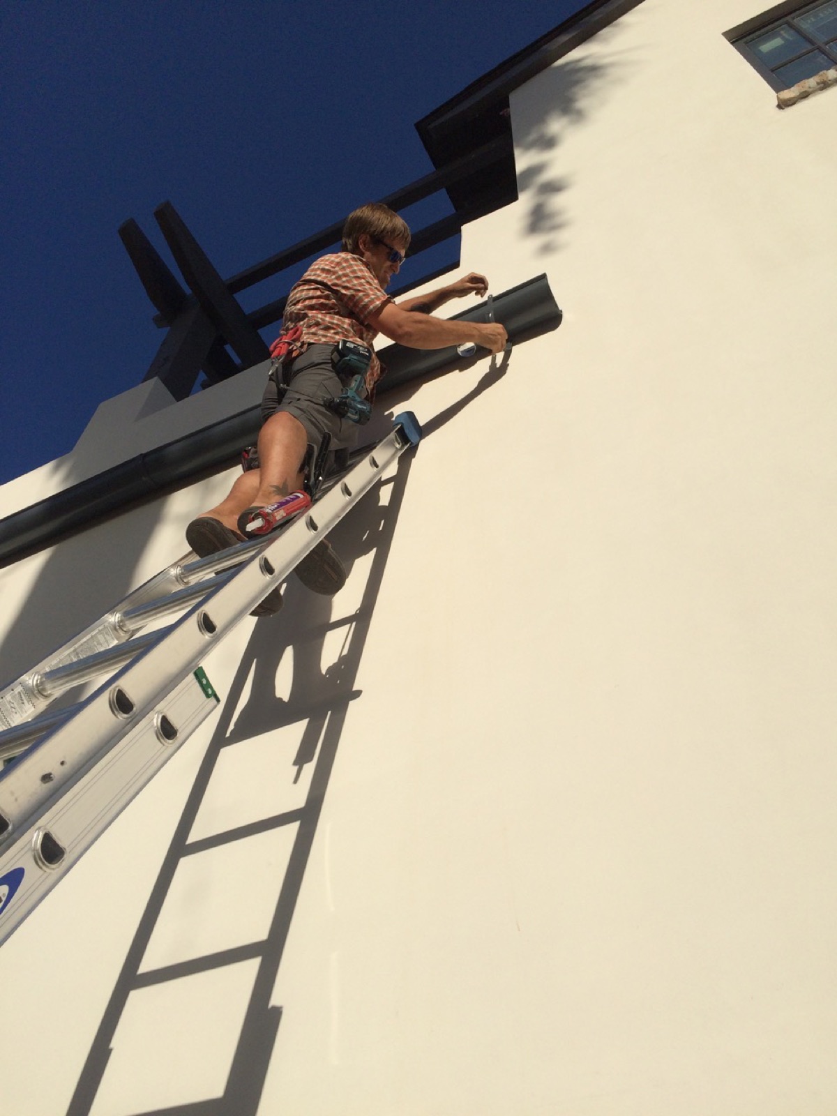 City Seamless rain gutter installation crew and equipment photo.