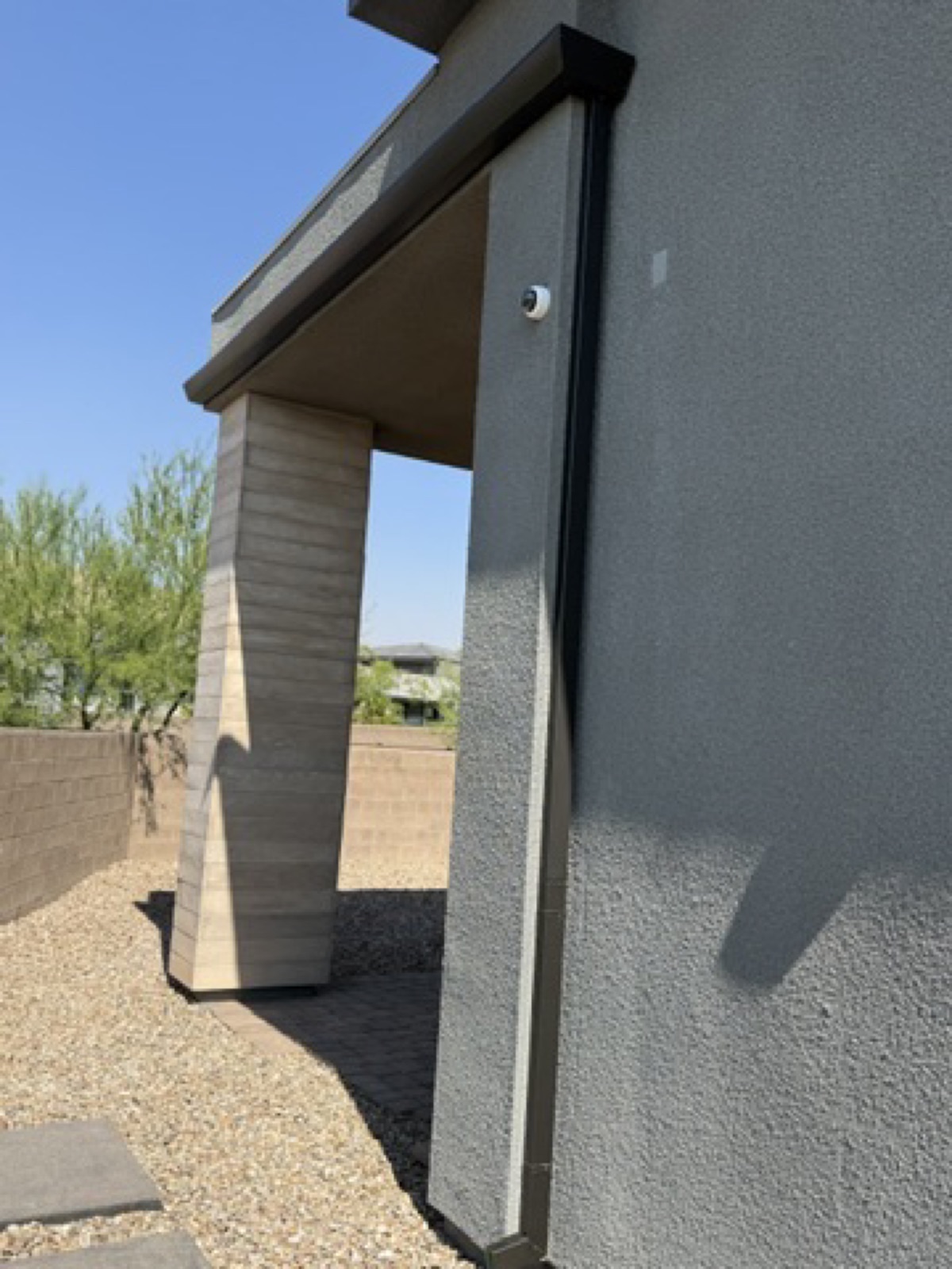 City Seamless straight-face gutter with downspout routing on a modern roofline.