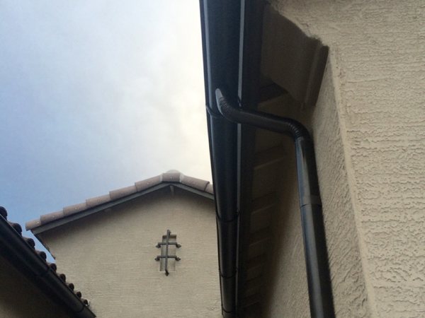 City Seamless half-round rain gutter with downspout routing on a custom home.