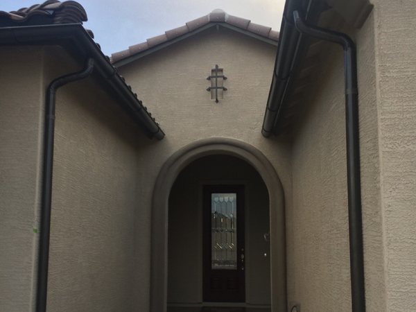 City Seamless half-round rain gutter with downspout routing on a custom home.