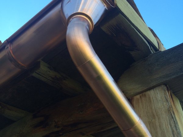 City Seamless half-round rain gutter with downspout routing on a custom home.
