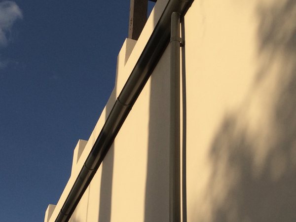 City Seamless half-round rain gutter installation on a custom home.