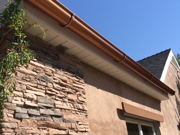 City Seamless half-round rain gutter installation on a custom home.