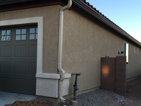 City Seamless K-style seamless rain gutter with downspout routing on a Southern Nevada home.