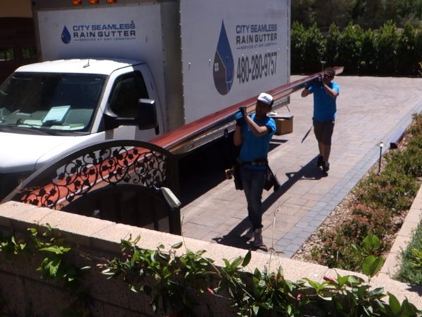 City Seamless rain gutter installation crew and equipment photo.