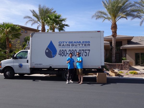 City Seamless rain gutter installation crew and equipment photo.