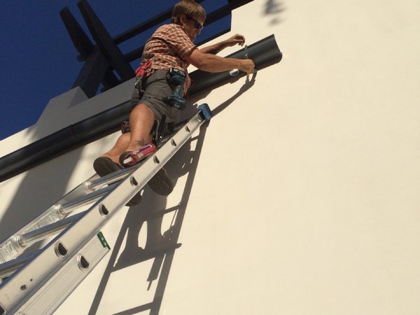 City Seamless rain gutter installation crew and equipment photo.