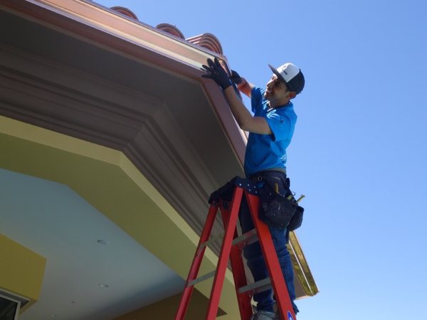 City Seamless rain gutter installation crew and equipment photo.