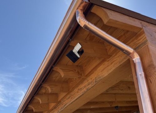 City Seamless half-round rain gutter with downspout routing on a custom home.