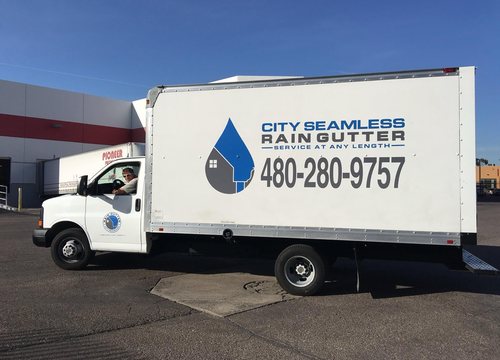 City Seamless rain gutter installation crew and equipment photo.